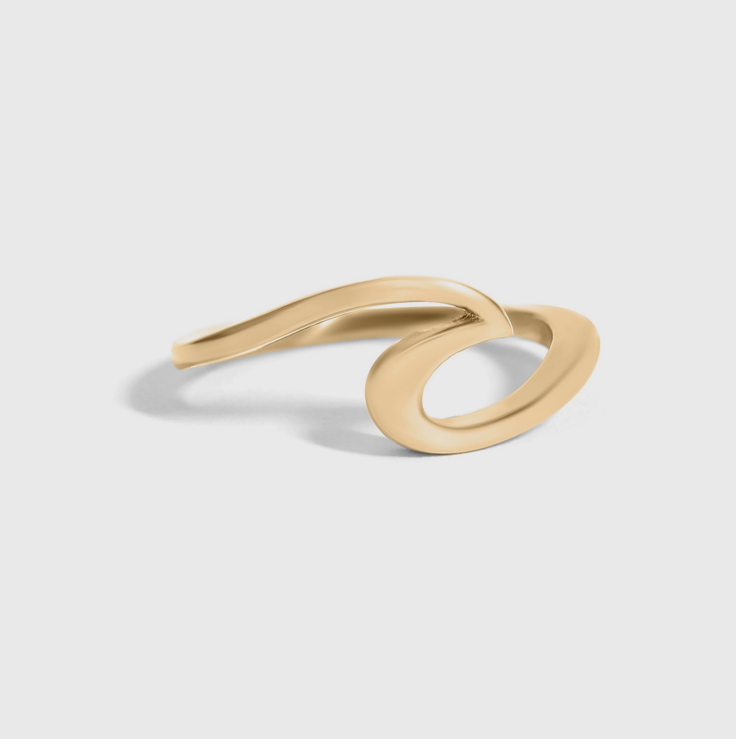 Gold ring with a modern design on a light gray background